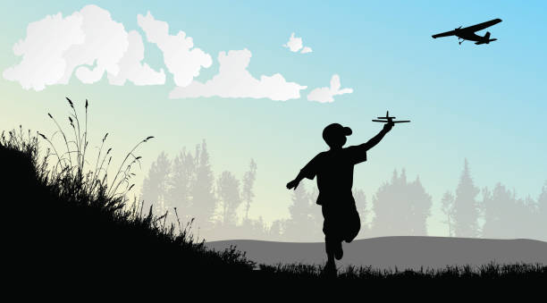 A Childs Dream Of Flight Boy playing with a toy airplane in an open field while a real airplane is flying in the sky airplane silhouettes stock illustrations