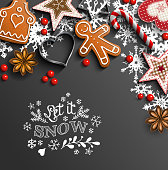 Christmas background, gingerbread cookies, ornaments, candy canes and anise stars laying on black background, with text Let it snow, vector illustration, eps 10 with transparency