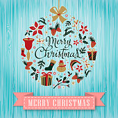 Christmas graphic elements form a Christmas ornament,  vintage blue color wooden background with paper scroll.