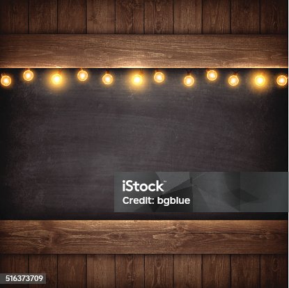 istock Christmas Lights on Wooden Boards and Chalkboard 516373709