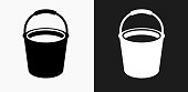 Cleaning Bucket Icon on Black and White Vector Backgrounds. This vector illustration includes two variations of the icon one in black on a light background on the left and another version in white on a dark background positioned on the right. The vector icon is simple yet elegant and can be used in a variety of ways including website or mobile application icon. This royalty free image is 100% vector based and all design elements can be scaled to any size.