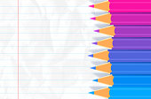 Colored pencils on lined notebook paper with space for copy gradient background pattern.