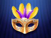 Colorful feather masquerade mask with diamonds. Carnival or party, festival celebration golden face cover. Part of theater costume. Colombina masque design for mardi gras festive. Celebration theme