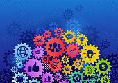 Multi colored connected gears with icons in it symbolizing business strategy, success, teamwork, communication concepts. In the background is dark blue halftone and gears. Diversity teamwork concept.