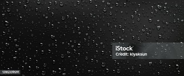 istock Condensation water drops on black glass background 1285339591