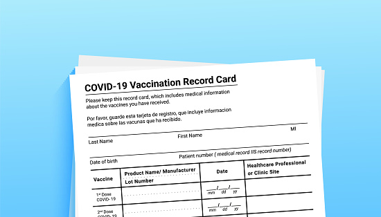 Coronavirus vaccination record card on blue background with copy space for travel and movement without borders. Vaccination form during the coronavirus covid 19 epidemic