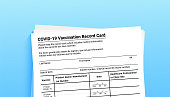 istock Coronavirus vaccination record card on blue background with copy space for travel and movement without borders. Vaccination form during the coronavirus covid 19 epidemic 1312253694