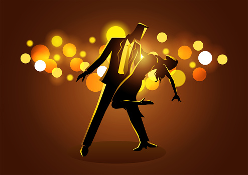 Couple dancing while standing against bokeh light background