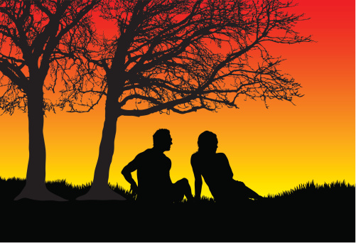 Couple under a tree at sunset