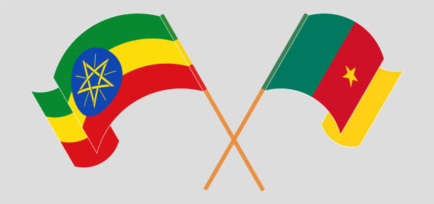 скрещенные и развевающиеся флаги эфиопии и камеруна - cameroon stock illustrations