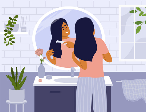 Daily morning routine concept with cute girl in bathroom combing hair