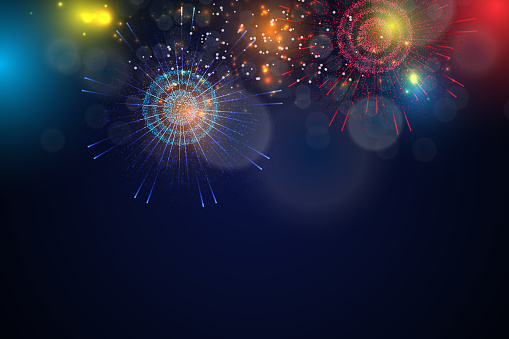 Decorative colorful fireworks explosions isolated on dark background.