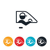An icon of a delivery driver driving vehicle. The delivery driver wears a baseball cap and has his arm out the window of the vehicle.