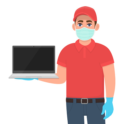 Delivery man or courier in mask and gloves showing blank laptop computer. Person holding latest PC. Modern technology. Corona virus epidemic outbreak. Safety online shopping service during quarantine.