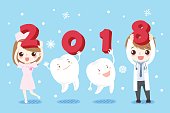 doctor and tooth with happy new year on the blue background