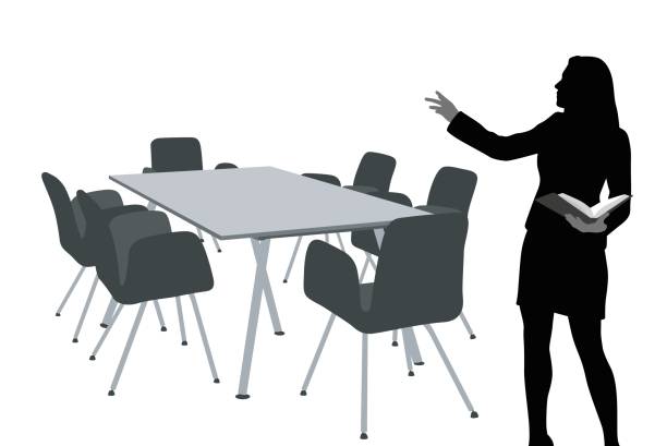 Done1 A vector silhouette illustration of a young, female professor preparing for a lecture to an empty table and chairs. teacher silhouettes stock illustrations