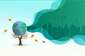 Save the forest, ecology, environment, reforestation, earth day concept and global warming awareness. Dry tree holding globe planet with city building in smoke pollution background.