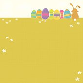 Vector illustration of a grassy field with a bunny with Easter eggs sitting and enjoying the view.