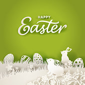 Paper cutting for Easter with bunnies and eggs on green background