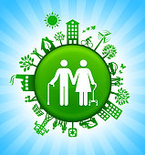 Elderly Couple Environment Green Button Background on Blue Sky. The main icon is placed on a round green shiny button in the center of the illustration. Environmental green living lifestyle icons go around the circumference of the button. Green building, man on a bicycle, trees, wind turbine, alternative energy and other environmental conservation symbols complete this illustration. The background has a blue glow effect.