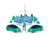 istock Electric cars charging on green renewable solar wind energy charger station with charging stall 1340659100