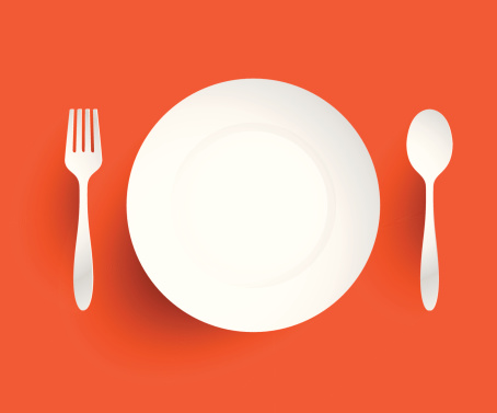 Empty dish, fork and spoon placed alongside. On orange backgroun