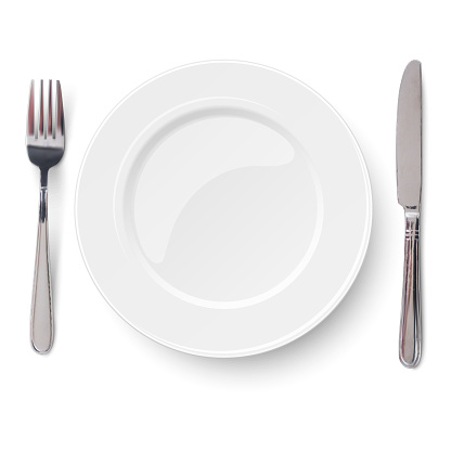 Empty plate with knife and fork isolated on a white background. View from above.