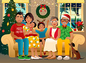 Family sitting on a sofa. Christmas decorations and warm cozy atmosphere.