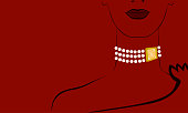 Fashion portrait of a woman with a pearl necklace on her neck on a red background