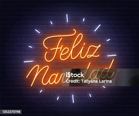 istock Feliz Navidad neon text. Greeting card on brick wall background. 1353370198