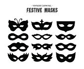 Set of festive vintage carnival masks silhouettes isolated over white. EPS10 vector.
