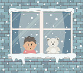 Window on a brick wall on a snowy day. A little boy in the room is surprised, looking at the snow. There is also a teddy bear on the windowsill. View from the street side. Winter background. Vector