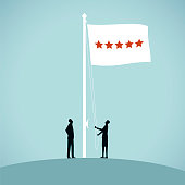 Two people raise a flag to celebrate a star performance