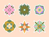 6 Unique geometric flower icons. Cute flower badges, stickers. Vector. Isolated on colored background.