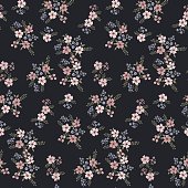Floral seamless pattern of small flowers in pastel colors on a dark blue background