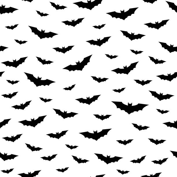 Flying bats seamless pattern Flying bats seamless pattern. Happy Halloween background. Black and white vector illustration. bat stock illustrations