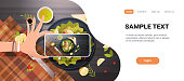 food blogger taking mobile photo of fresh vegetable salad with chicken and sauce in black bowl top angle view smartphone screen social network activity concept copy space horizontal vector illustration