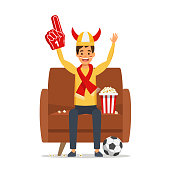 Football match supporting. Man celebrating goal. Sport fan sits on the sofa. Vector stock