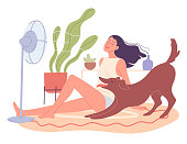 Girl and her dog are chilling at home by the fan.