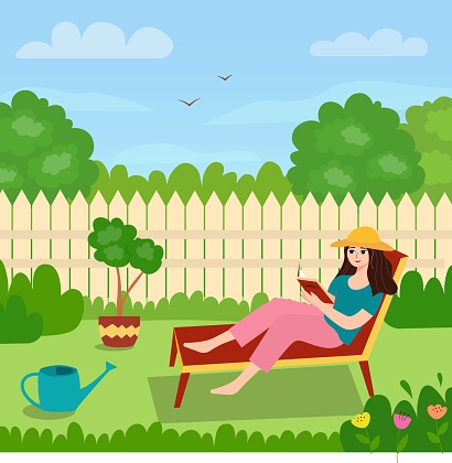 A girl on a lawn chair in the backyard reading a book.