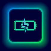 istock Glowing neon line Battery icon isolated on black background. Lightning bolt symbol. Colorful outline concept. Vector 1357921469