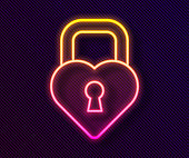 istock Glowing neon line Castle in the shape of a heart icon isolated on black background. Locked Heart. Love symbol and keyhole sign. Vector 1279998316
