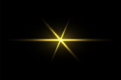 Gold light beams on black background