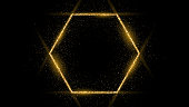 Golden hexagon frame with glitter, sparkles and flares on dark background. Empty luxury backdrop. Vector illustration.