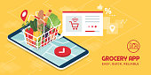 Grocery delivery at home and smartphone app: full shopping basket with fresh vegetables, food and beverage on a mobile phone display