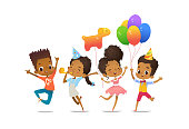 istock Group of African-American happy boys and girls with the balloons and birthday hats happily jumping with their hands up. Birthday party vector illustration for website banner, poster, flyer, invitation 1143070814