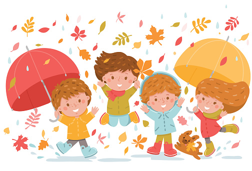 Group of kids playing and jumping in the falling autumn leaves
