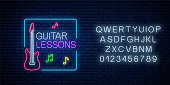 Guitar lessons glowing neon poster or banner template with alphabet. Guitar training advertising flyer in neon style on dark brick wall background. Vector illustration.