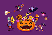 istock Halloween monsters filling carved pumpkin with candies and sweets 1279616528