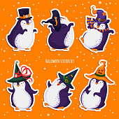 Halloween set of cute vector dancing  penguins. Different hats, various poses. All elements are isolated. Pre-made stickers.